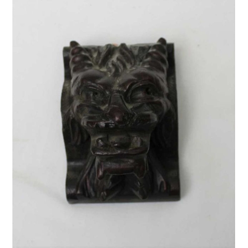 145 - A small carved oak lion mask, 10cm, together a pair of carved oak lion mounts, 31cm