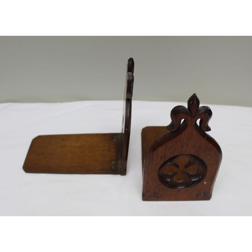 146 - A pair of carved oak Gothic design folding bookends, 19cm high