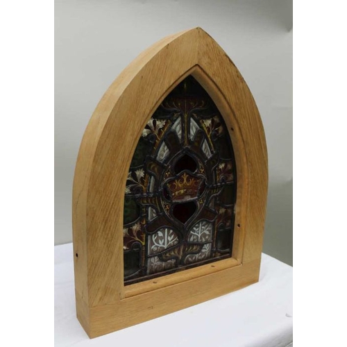 147 - A leaded and stained glass panel, with crown to centre, bespoke plain oak arch frame, 53cm high over... 