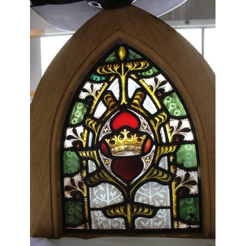 147 - A leaded and stained glass panel, with crown to centre, bespoke plain oak arch frame, 53cm high over... 