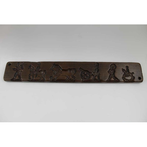 150 - A Dutch carved gingerbread board, with lion, soldiers, etc. 44cm x 7cm