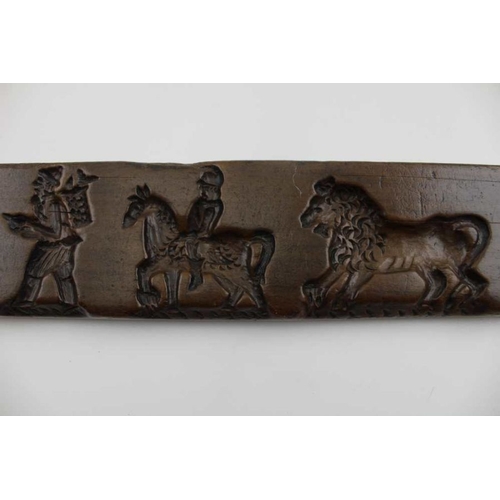 150 - A Dutch carved gingerbread board, with lion, soldiers, etc. 44cm x 7cm