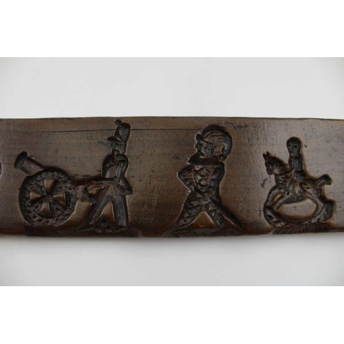 150 - A Dutch carved gingerbread board, with lion, soldiers, etc. 44cm x 7cm