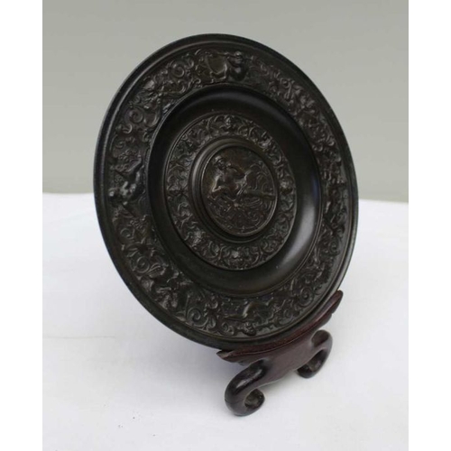 154 - A 19th century cast bronze roundel, Classical figure to centre with lyre, surrounded by a border wit... 