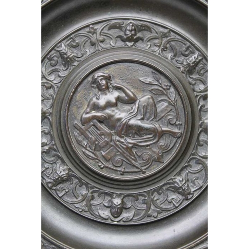 154 - A 19th century cast bronze roundel, Classical figure to centre with lyre, surrounded by a border wit... 