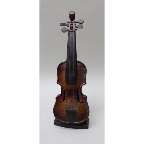 156 - A painted tin plate model violin, 31cm, on ebonised stand