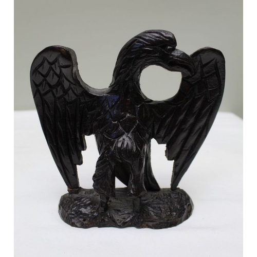 162 - A 19th century cast iron lion, 9cm high, together with a carved wood spread eagle, and a brass fox d... 