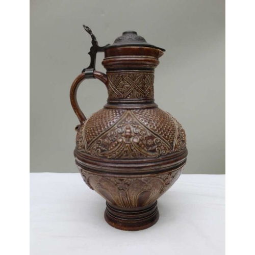 164 - A German moulded stoneware jug, with hinged pewter cover, c.1900, 27cm high