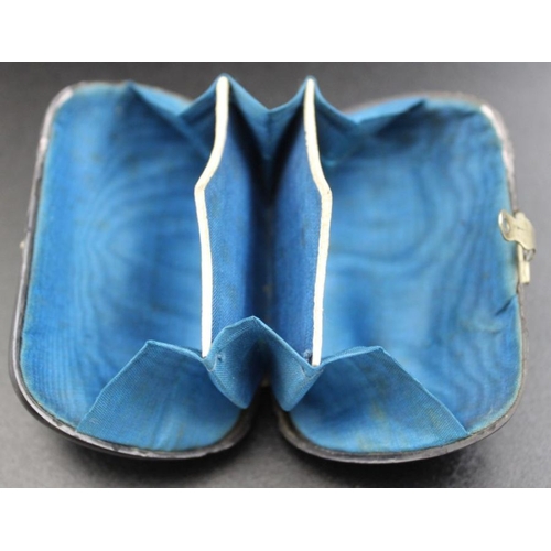 168 - A Victorian oval ebony purse with blue lining, inlaid shield 7 x4.5cm