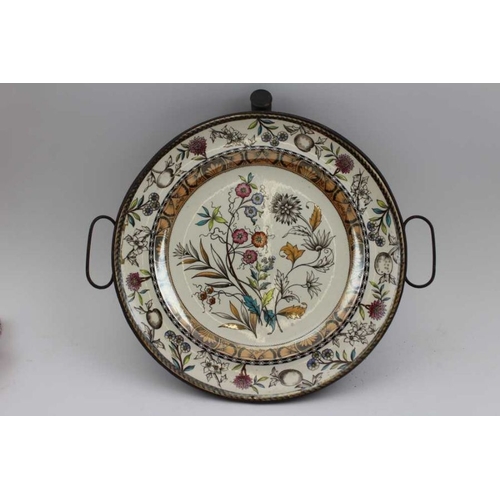 173 - A late 19th century plate / food warmer, the floral decorated plate set within a tin base to contain... 