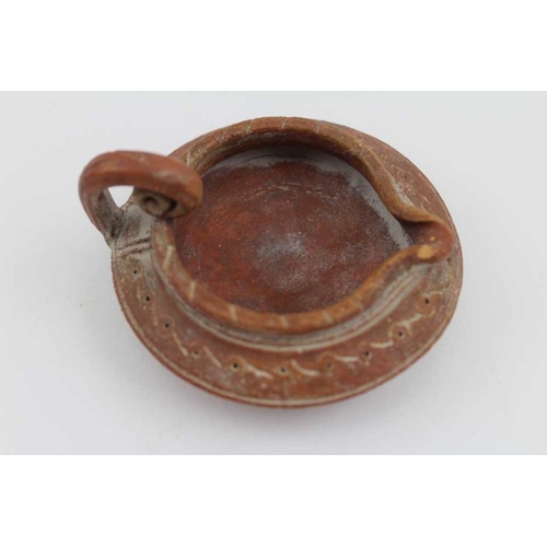 179 - Two terracotta items of Ancient Roman form, comprising an oil lamp and a small jug, the lamp is 8cm ... 