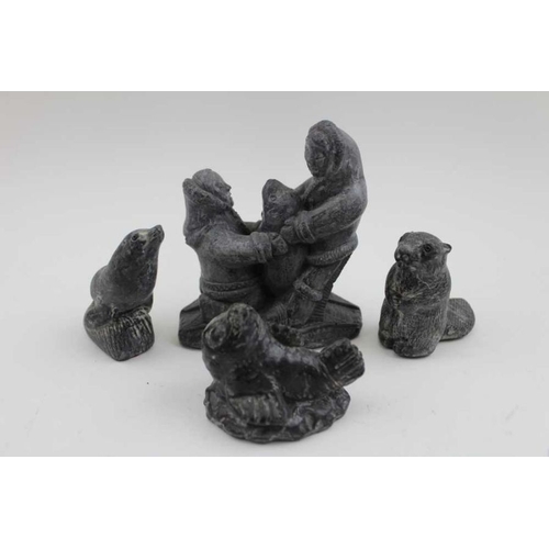 184 - A collection of eight Canadian Inuit effect carvings, the largest depicts two figures wearing snow s... 