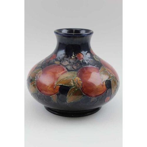 196 - An early 20th century Moorcroft vase tube lined and painted on a cobalt blue grown Anemone pattern, ... 