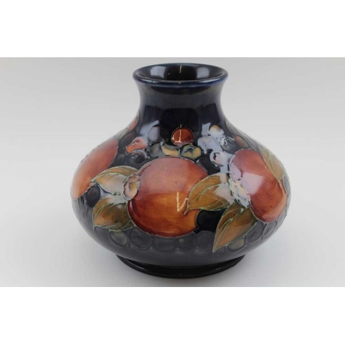 196 - An early 20th century Moorcroft vase tube lined and painted on a cobalt blue grown Anemone pattern, ... 