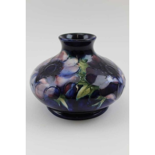 197 - An early 20th century Moorcroft vase tube lined and painted on a Coalport blue grown Anemone pattern... 