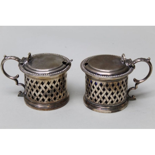 23 - A glass biscuit barrel with silver plated lid, together with a pair of silver plated drum mustards, ... 