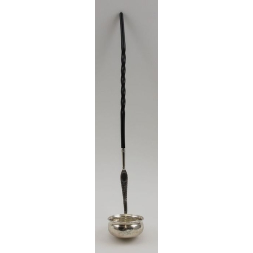 25 - An 18th century silver toddy ladle, the bowl inset a George II sixpence, bright cut decoration to th... 