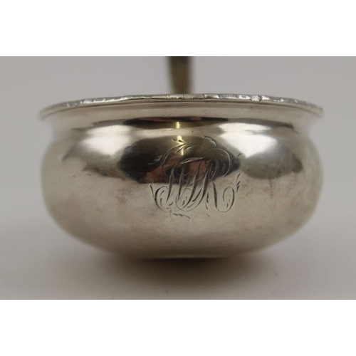 25 - An 18th century silver toddy ladle, the bowl inset a George II sixpence, bright cut decoration to th... 