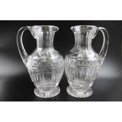 255 - A set of four early 19th century Georgian design facet cut jugs, with applied handles and star cut b... 