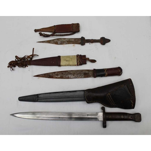 275 - A Sanderson of Sheffield double edged bayonet with scabbard, together with two ethnic tourist knives