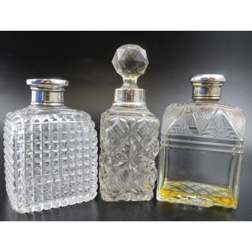 32 - William Neale, a pair of early 20th century silver lidded facet cut globular scent bottles, having s... 