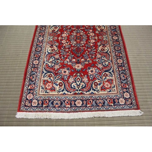 369 - A small Mahal floor rug, floral design on a red ground, 212cm x 137cm