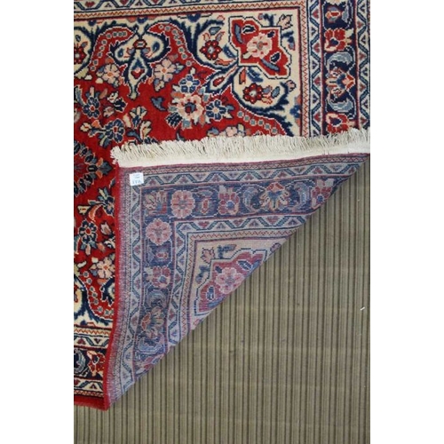 369 - A small Mahal floor rug, floral design on a red ground, 212cm x 137cm