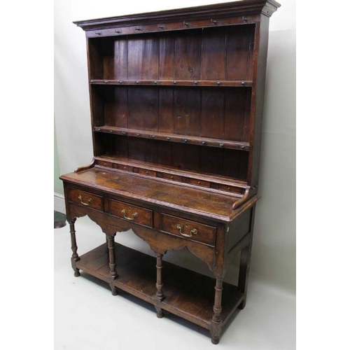 375 - A George III oak dresser, with plate rack back, a run of small drawers above the base fitted three d... 