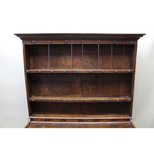 375 - A George III oak dresser, with plate rack back, a run of small drawers above the base fitted three d... 