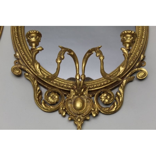 377 - A pair of late 19th century continental gilt framed Girondelle wall mirrors with candle sconces, pla... 