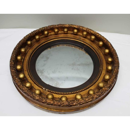 388 - A 19th century Regency design circular gilt framed convex wall mirror, with bead set frame, overall ... 