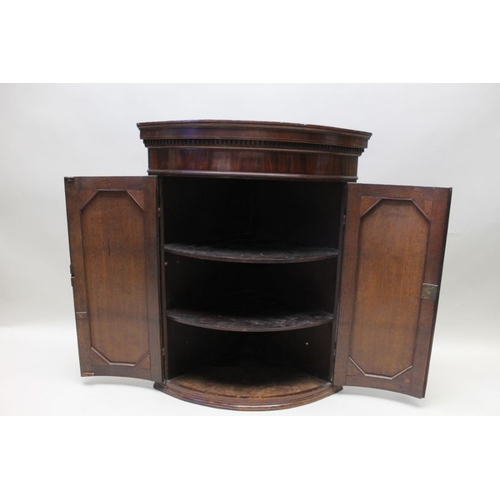 391 - A George III oak bow front hanging corner cupboard, with dentil cornice and mahogany inlay, 91cm hig... 