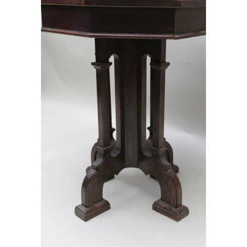 394 - A 19th century oak lamp table of Gothic design, octagonal top, on cluster supports and four arched f... 