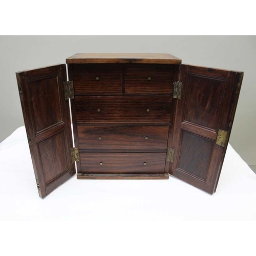 399 - A 19th century mahogany cabinet fitted two doors with sunburst panels, opening to reveal drawers ins... 