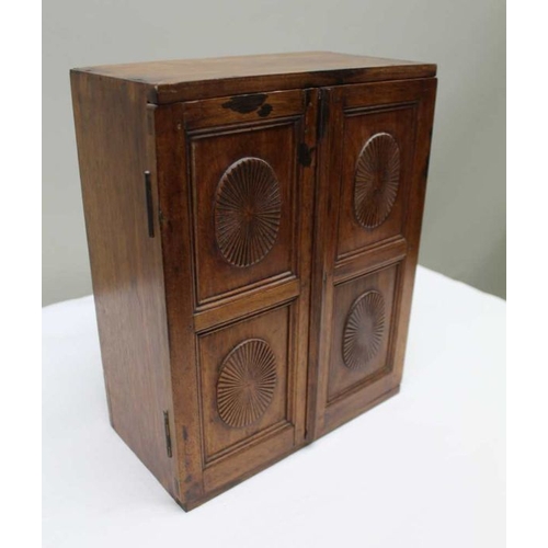 399 - A 19th century mahogany cabinet fitted two doors with sunburst panels, opening to reveal drawers ins... 