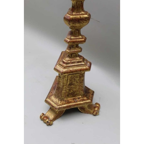 405 - An Italian gilt wood candlestick, 129 cm tall