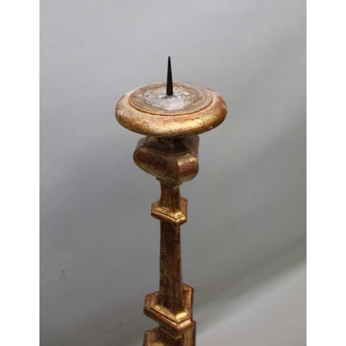 405 - An Italian gilt wood candlestick, 129 cm tall