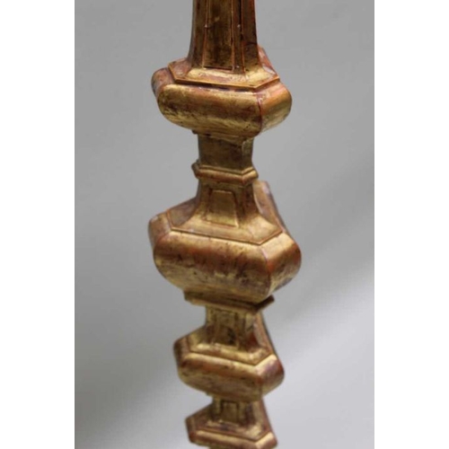 405 - An Italian gilt wood candlestick, 129 cm tall