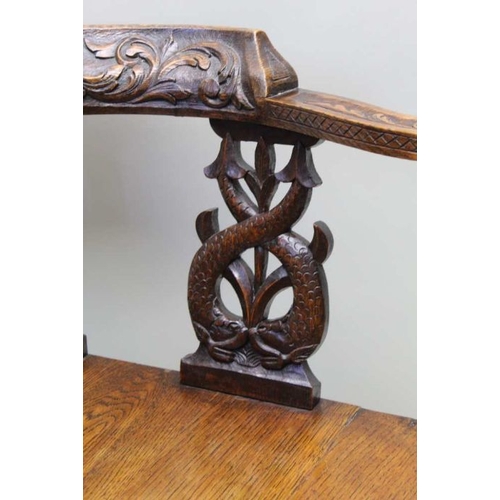 413 - A Victorian 17th century design oak corner chair with carved horse shoe crest on double dolphin supp... 