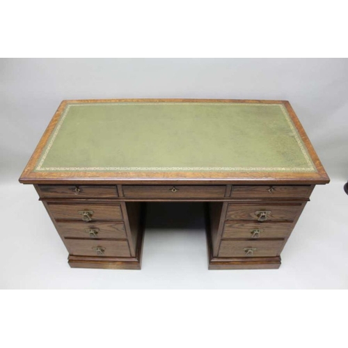 420 - A late Victorian oak twin pedestal desk with inset skiver top over three inline drawers upon two thr... 