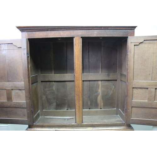 422 - A late 18th century Estate cupboard later adapted two piece oak, the upper section with panelled doo... 