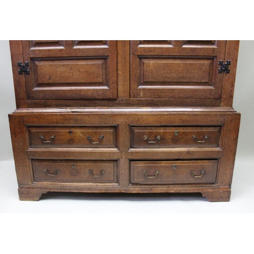 422 - A late 18th century Estate cupboard later adapted two piece oak, the upper section with panelled doo... 