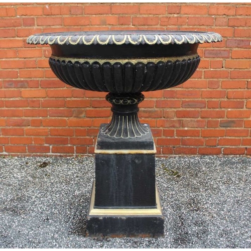 435 - An impressive black cast iron metal urn with everted egg and dart rim over a fluted body fluted foot... 