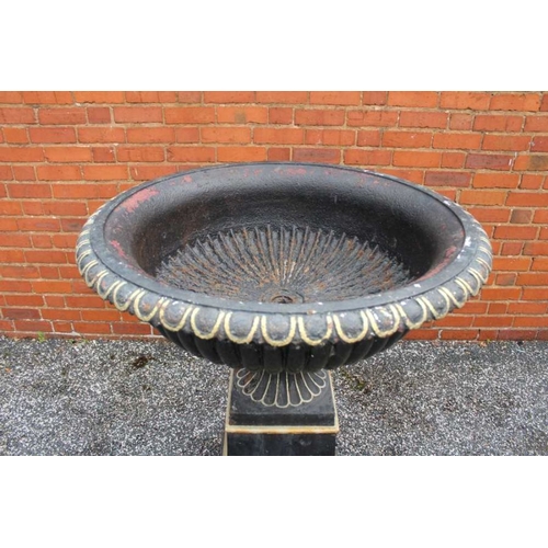 435 - An impressive black cast iron metal urn with everted egg and dart rim over a fluted body fluted foot... 