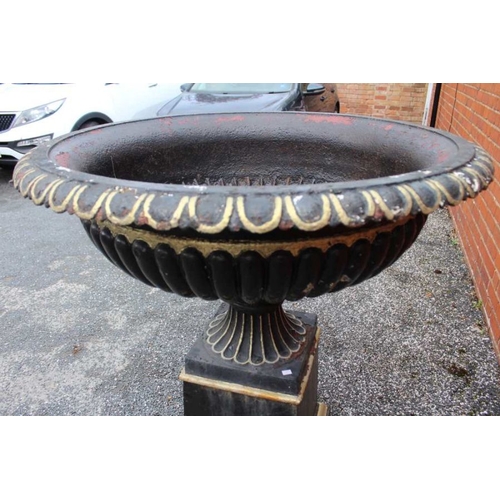 435 - An impressive black cast iron metal urn with everted egg and dart rim over a fluted body fluted foot... 