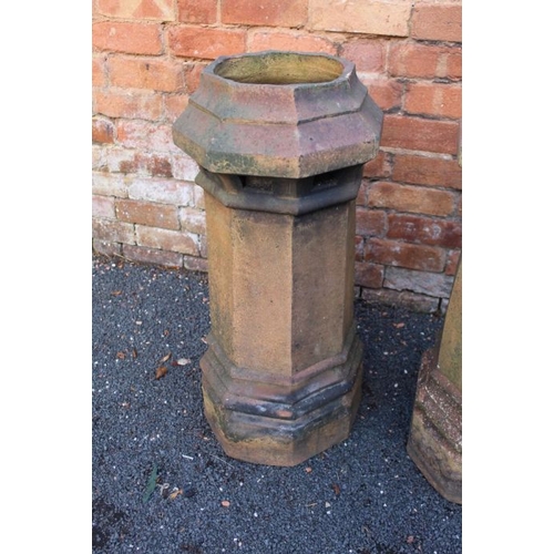 437 - A pair of stoneware chimney pots with octagonal tops, and flared stems, 75cm high