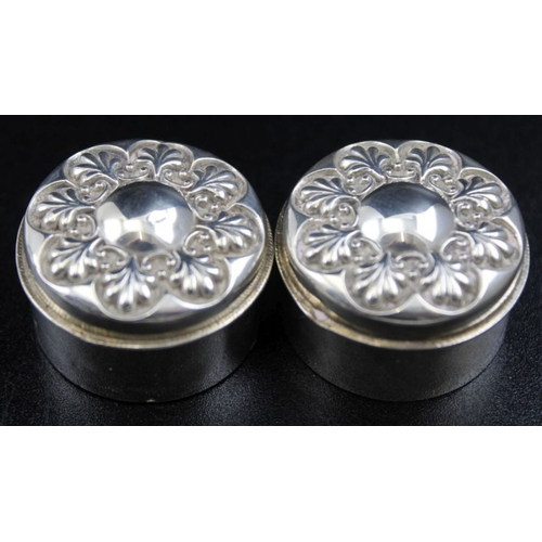 44 - A pair of small silver pill boxes with embossed lids and gilt interiors 3cm diameter, Birmingham 190... 