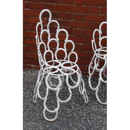 445 - A suite of garden furniture constructed from welded horseshoes, comprising two chairs, and a pair of... 