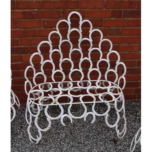 445 - A suite of garden furniture constructed from welded horseshoes, comprising two chairs, and a pair of... 