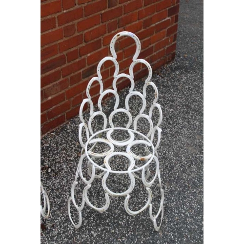 445 - A suite of garden furniture constructed from welded horseshoes, comprising two chairs, and a pair of... 